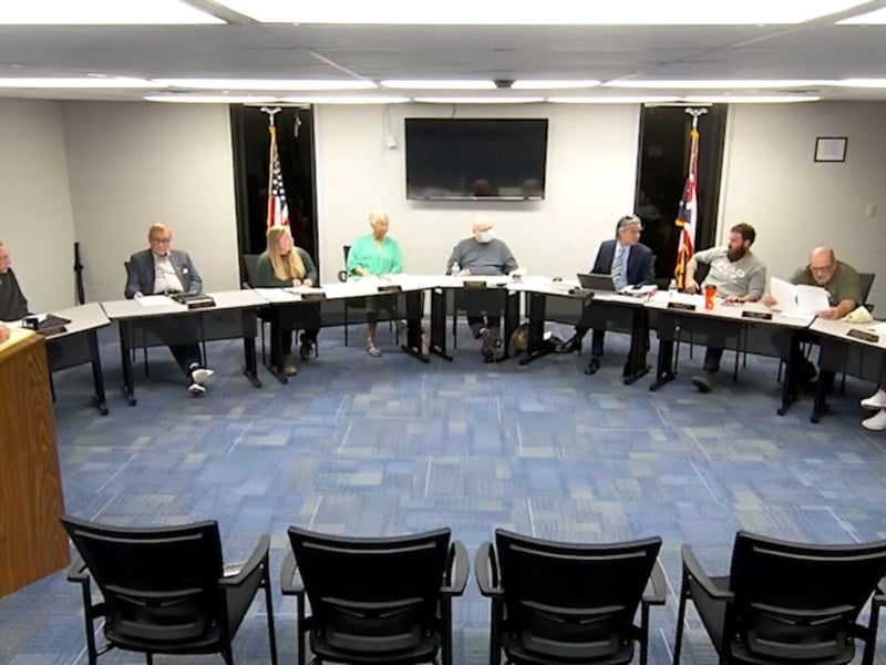 Nelsonville City Council sits around a table.