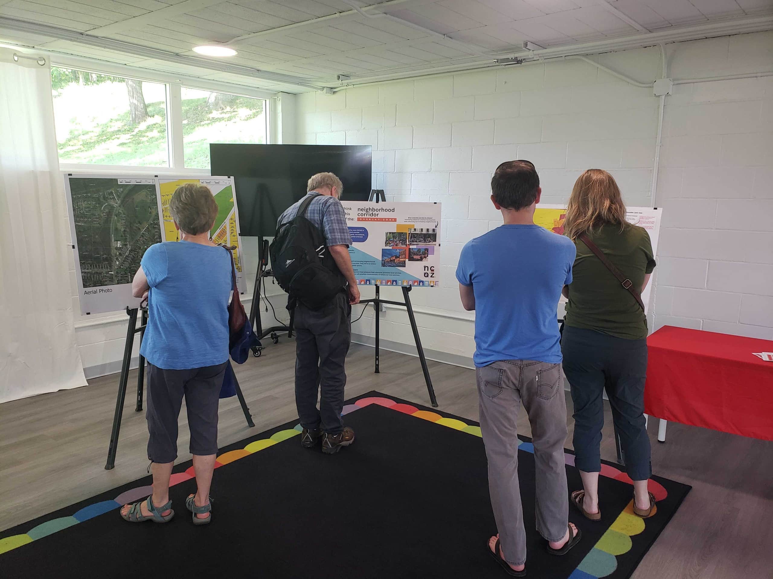 Attendees review a display set up at the Athens City Planning Commission meeting
