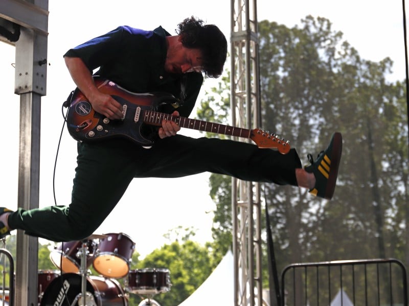 PAL guitarist mid-jump during their performance.