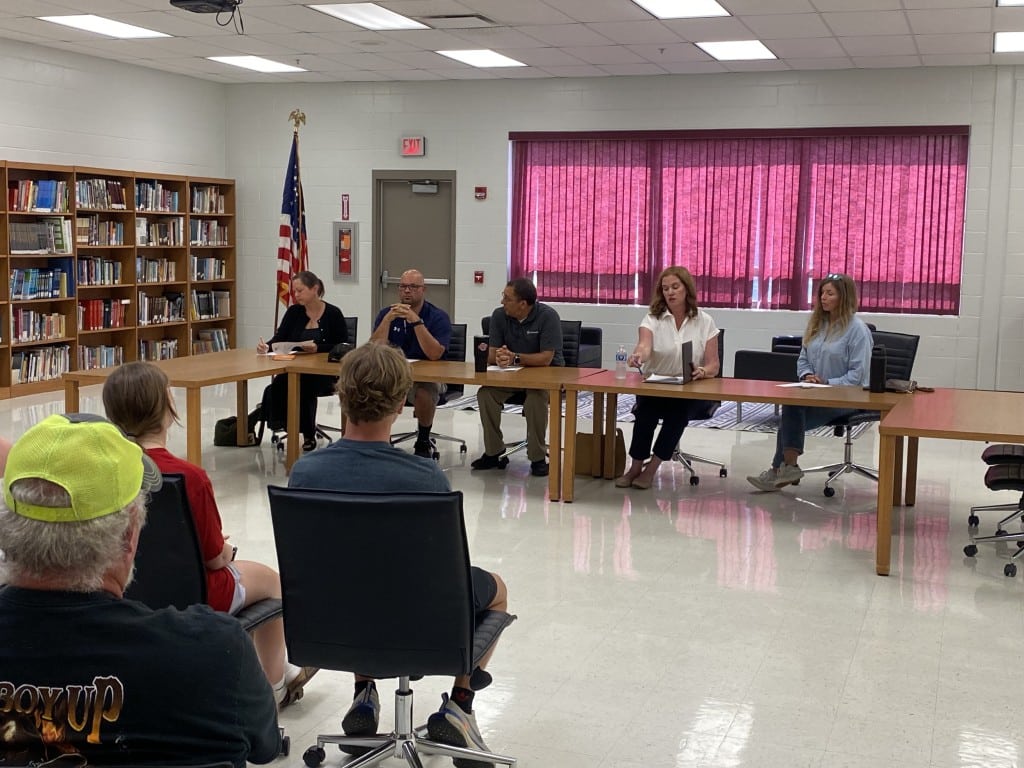 Group of people behind a table.
