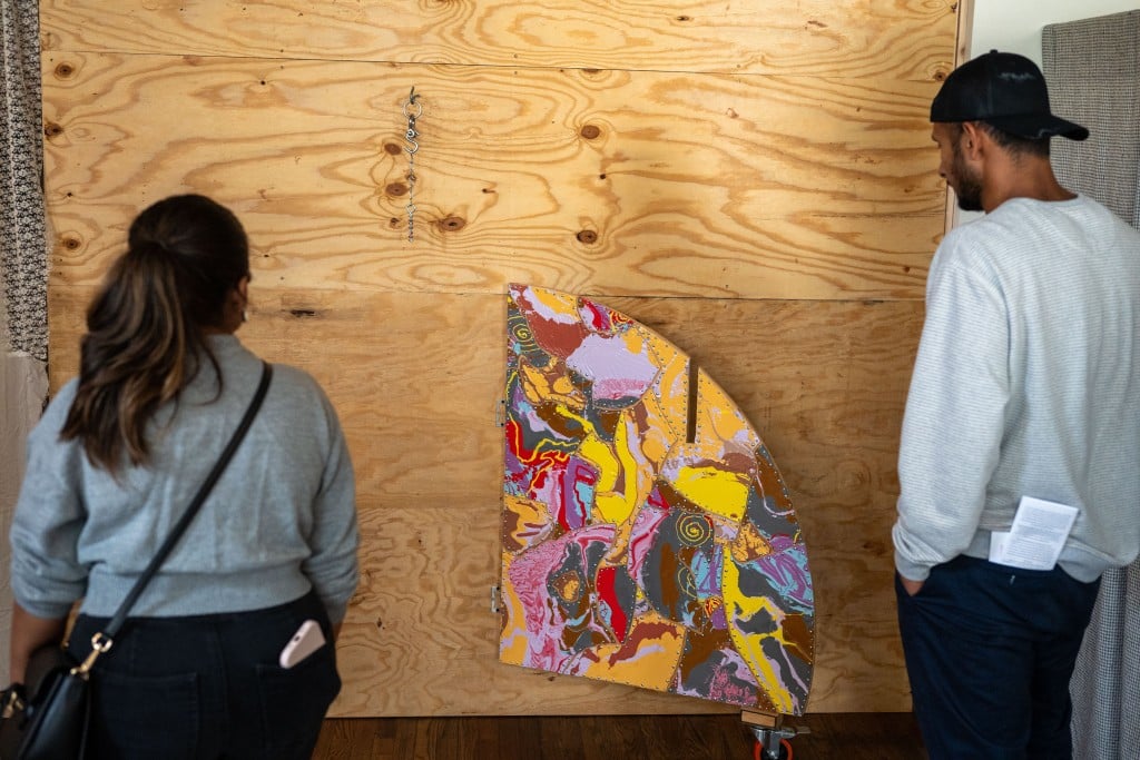 Two people looking at an art piece.