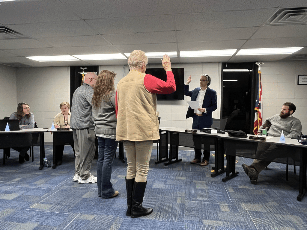 People standing being sworn in