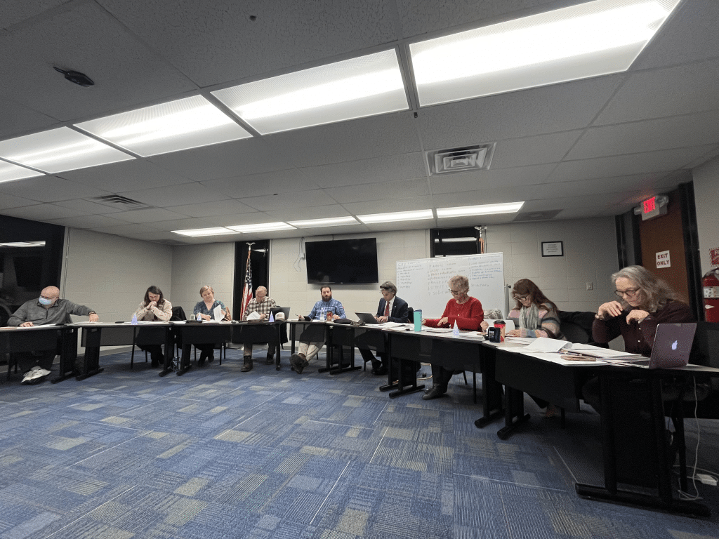 City council sitting behind tables.