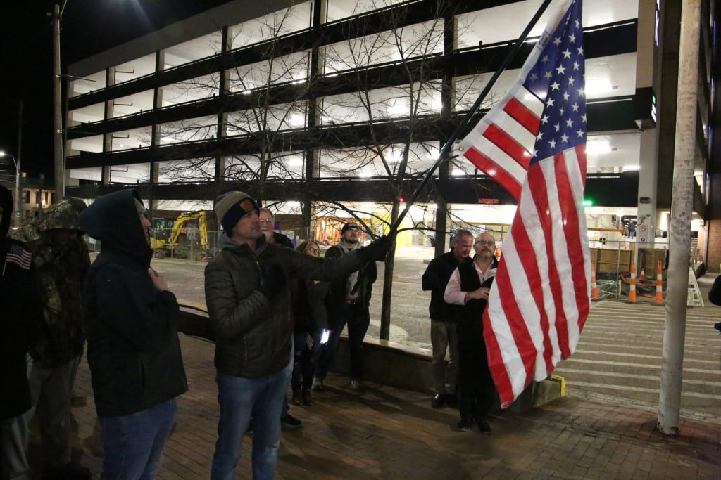 Men saying the Pledge of Allegiance. 